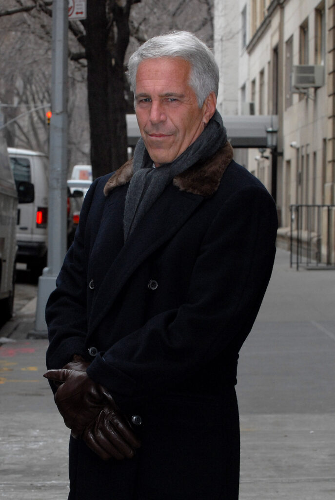 Jeffrey Epstein stands looking at the camera