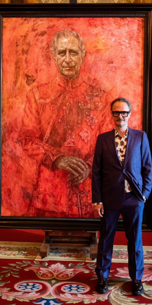 Artist Jonathan Yeo stood next to King Charles portrait