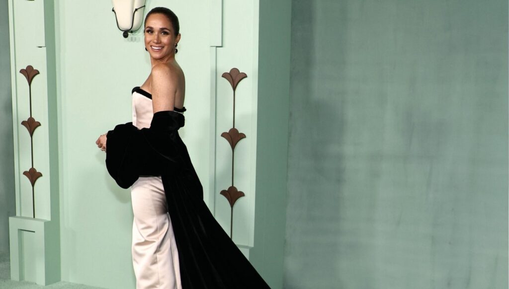 Meghan Markle smiling in strapless dress at gala