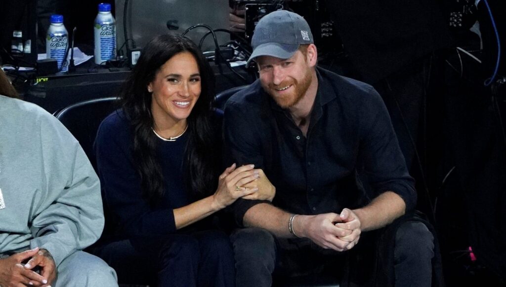 Meghan Markle and Prince Harry smiling and cuddling at NBA game