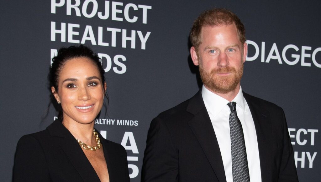 Meghan Markle and Prince Harry smiling at event