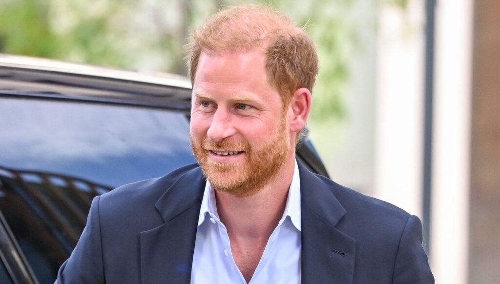 Prince Harry smiling during UK return