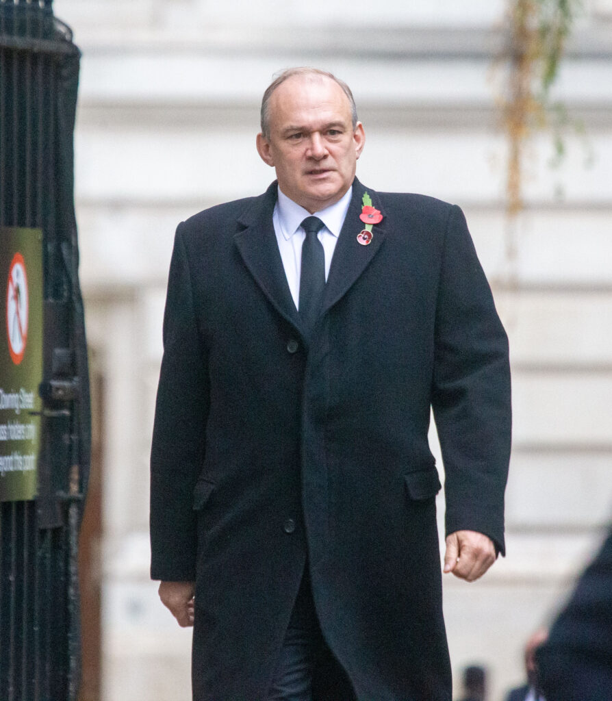 Ed Davey in a black coat and suit