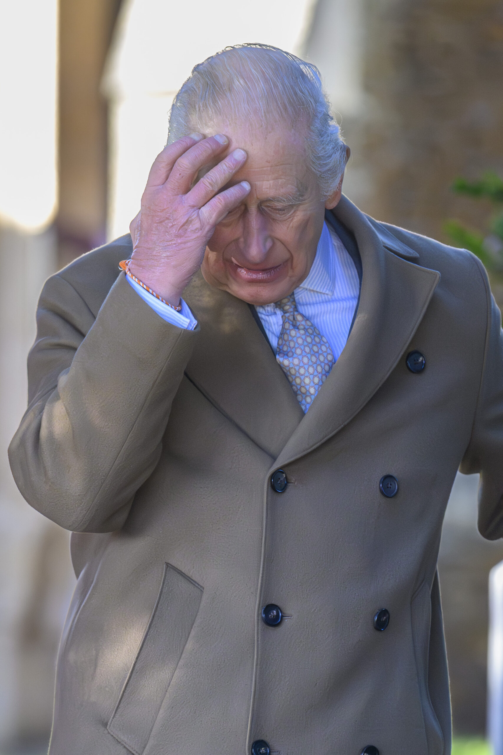 King Charles clutching his head