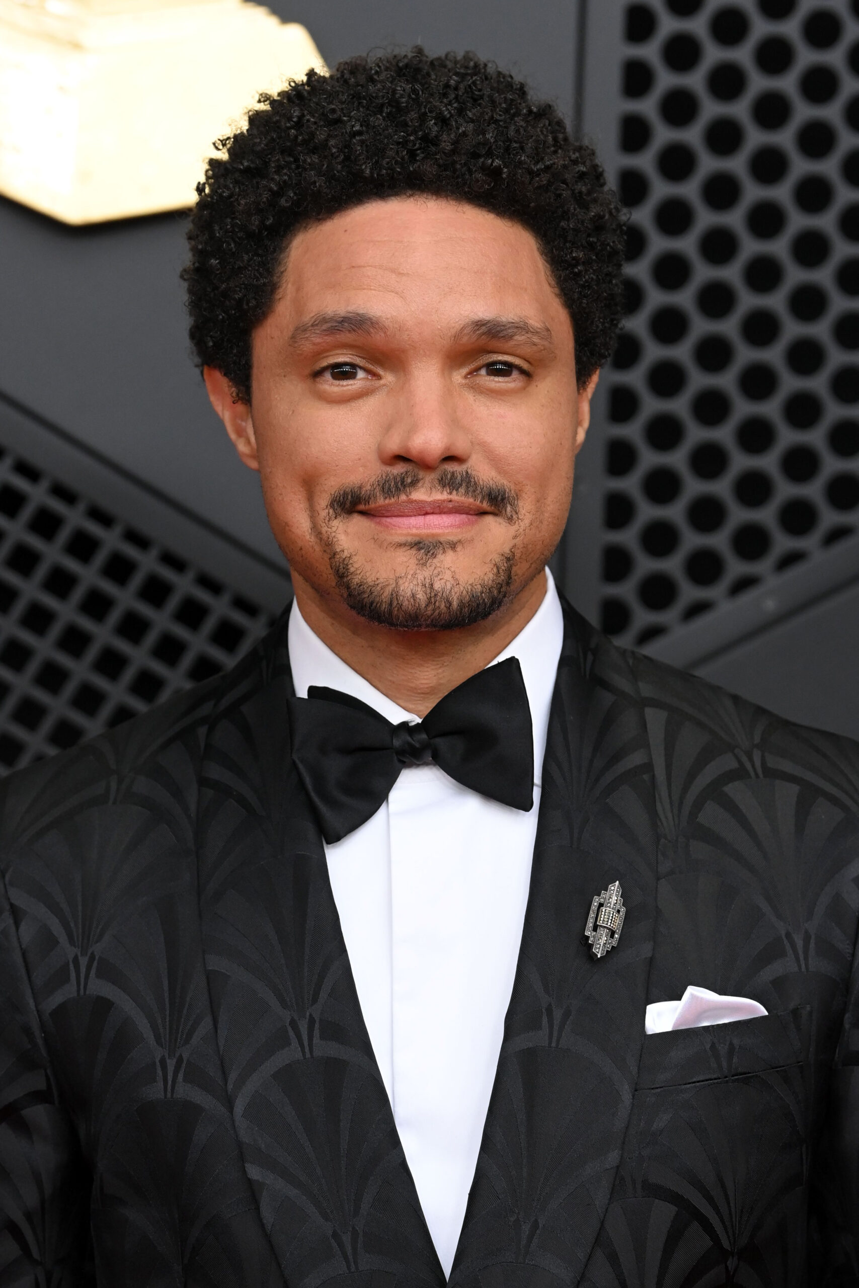 Trevor Noah smiling at The Grammys