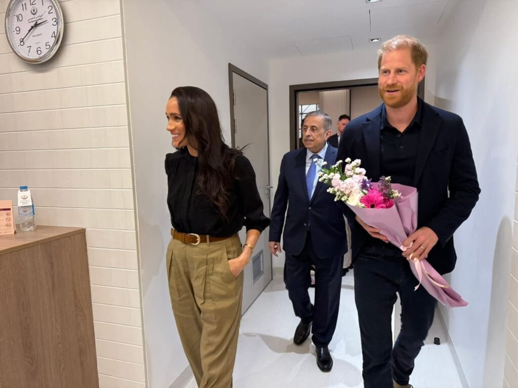 Meghan Markle and Prince Harry visiting a Jordan rehabilitation centre, Prince Harry holds a bunch of flowers