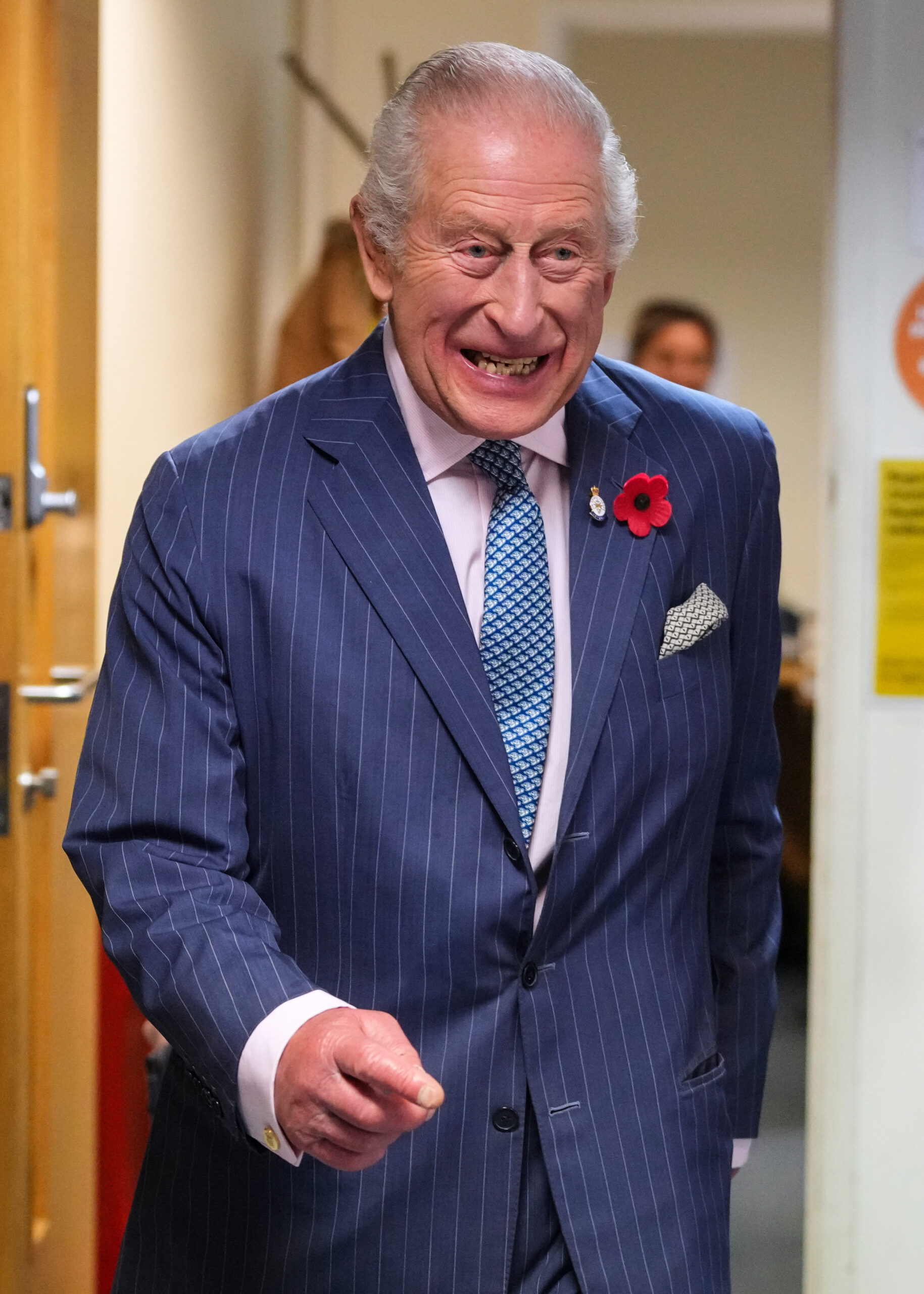 King Charles smiling as he walks forward