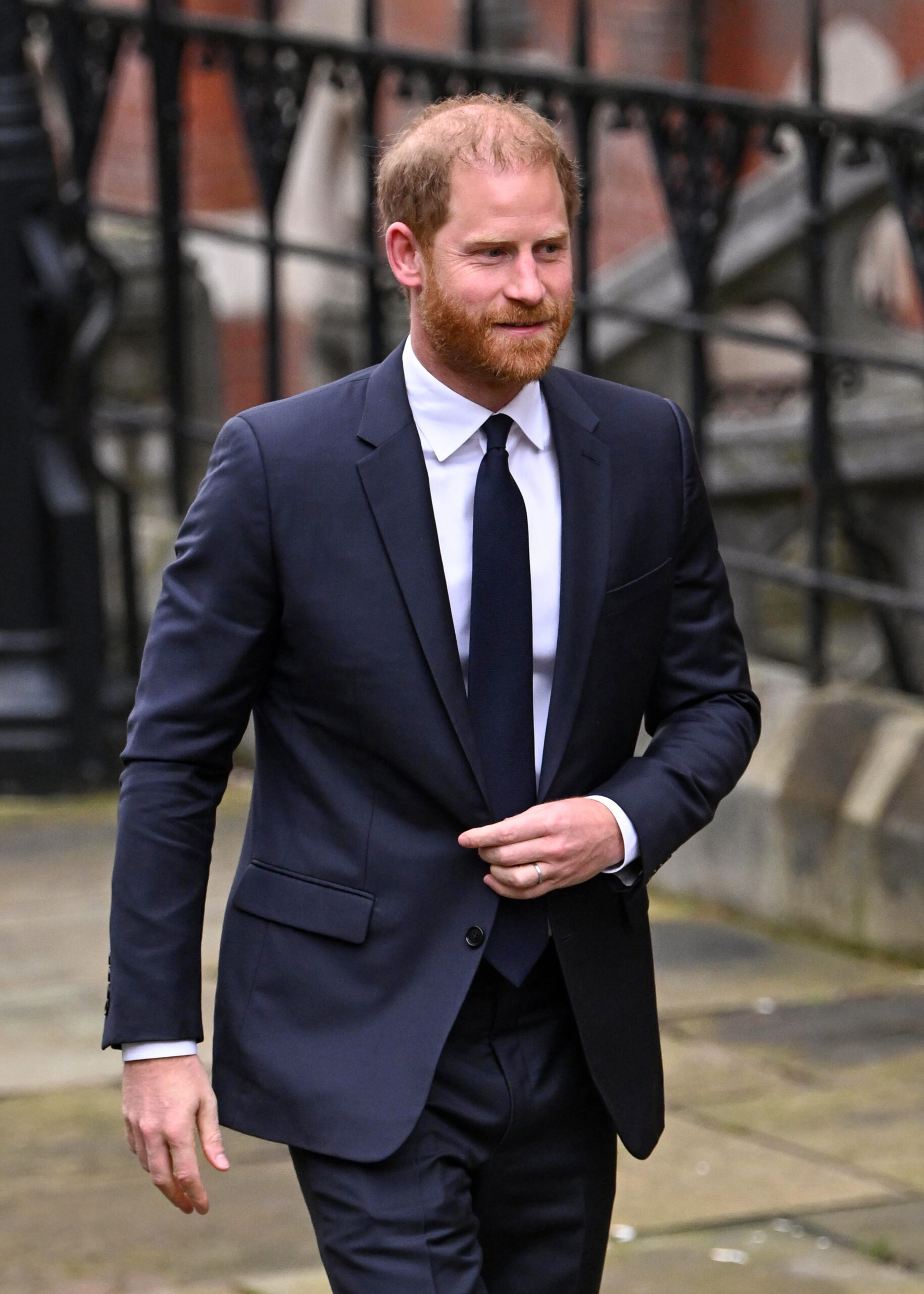 Prince Harry smiling wearing a suit 