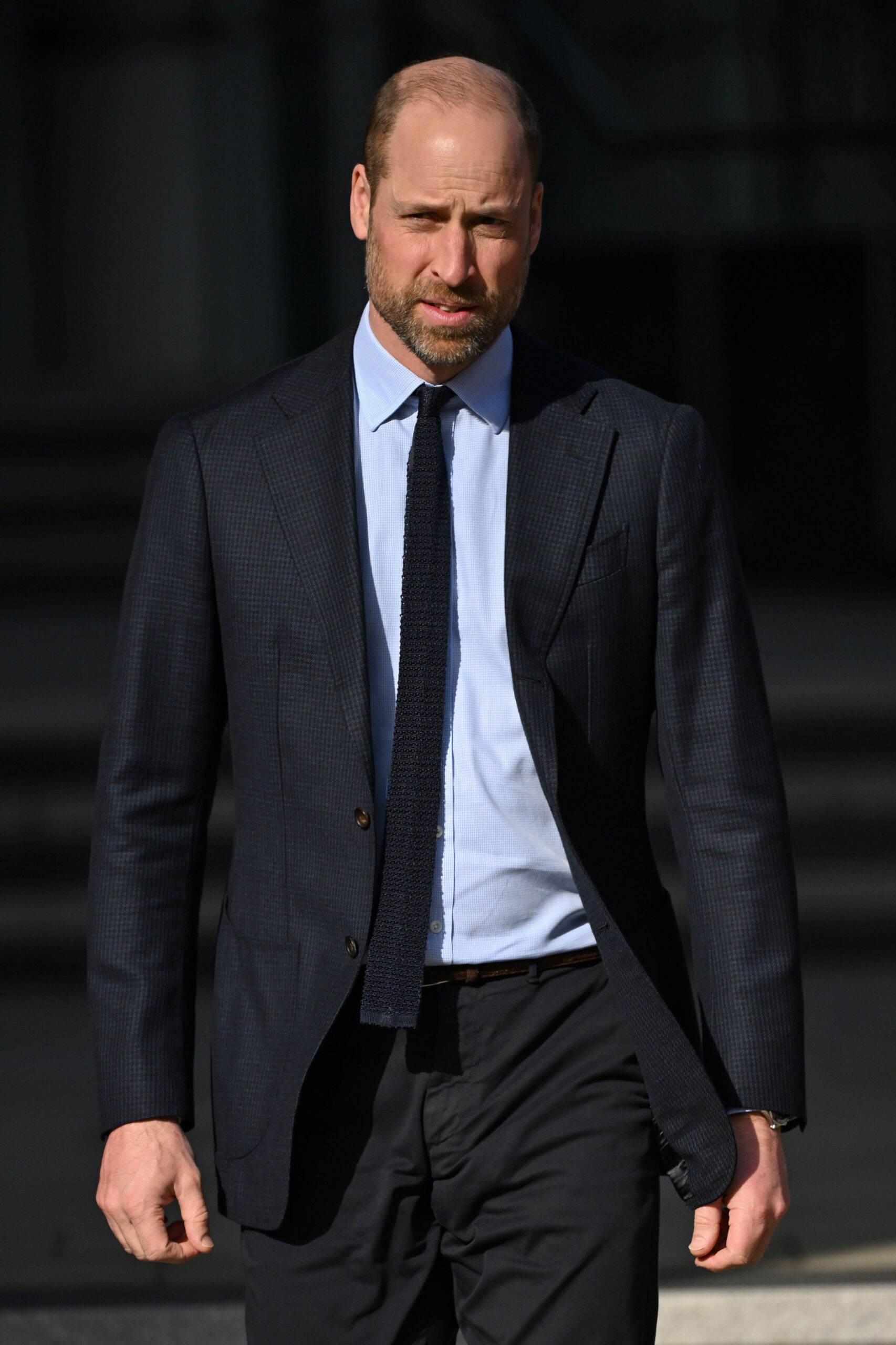 Prince William frowning as he walks