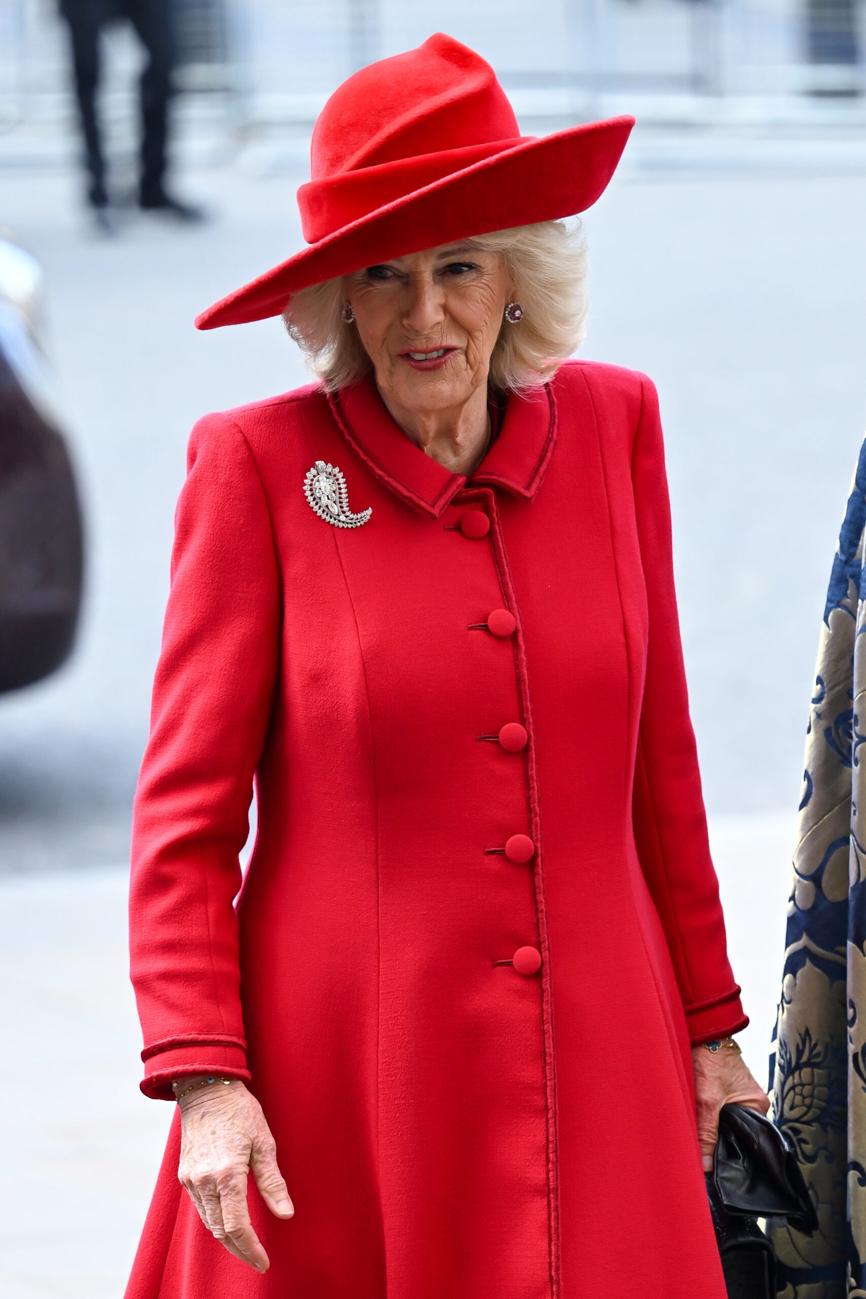 Queen Camilla smiling wearing red