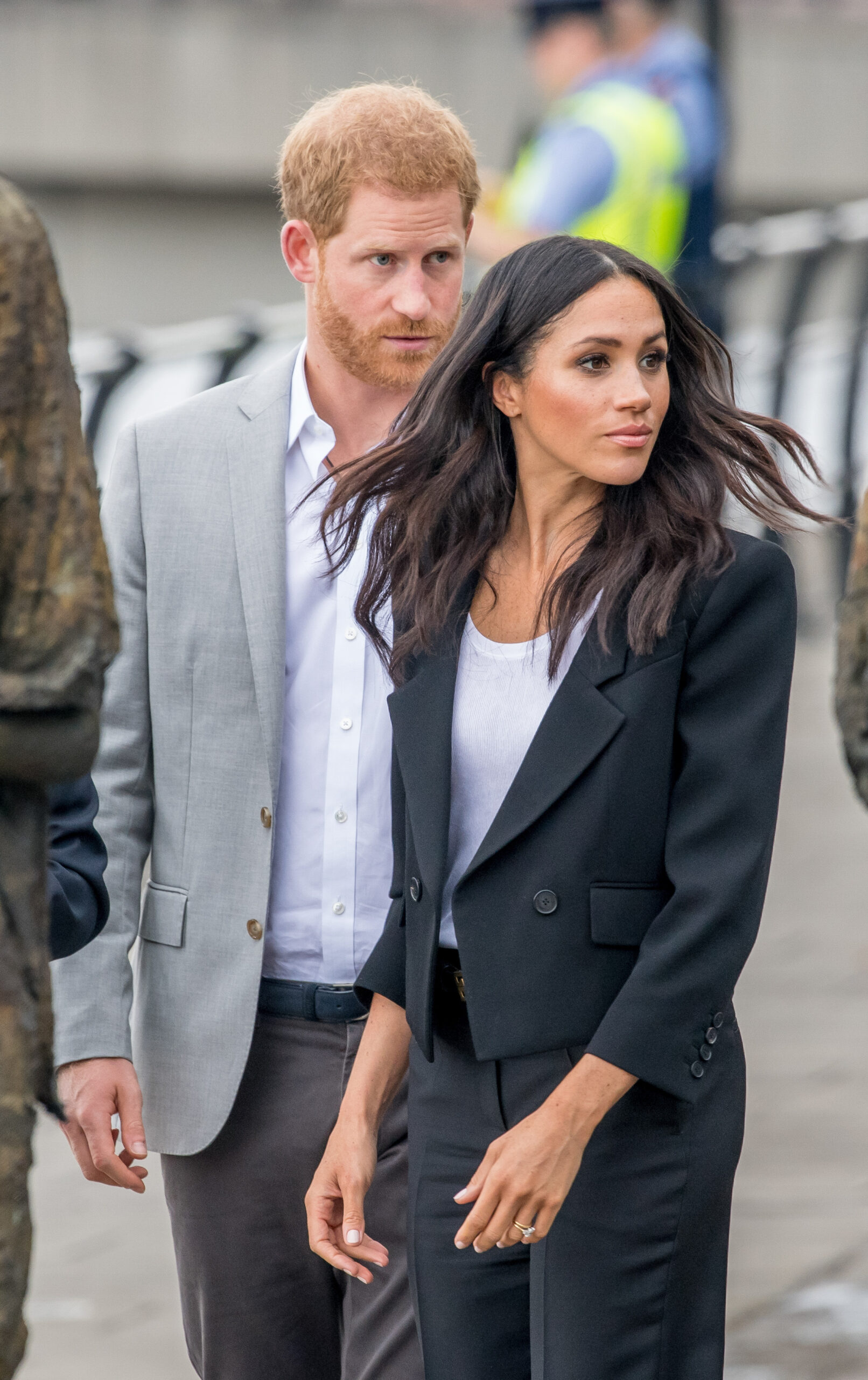 Prince Harry and Meghan Markle looking worried on royal engagement