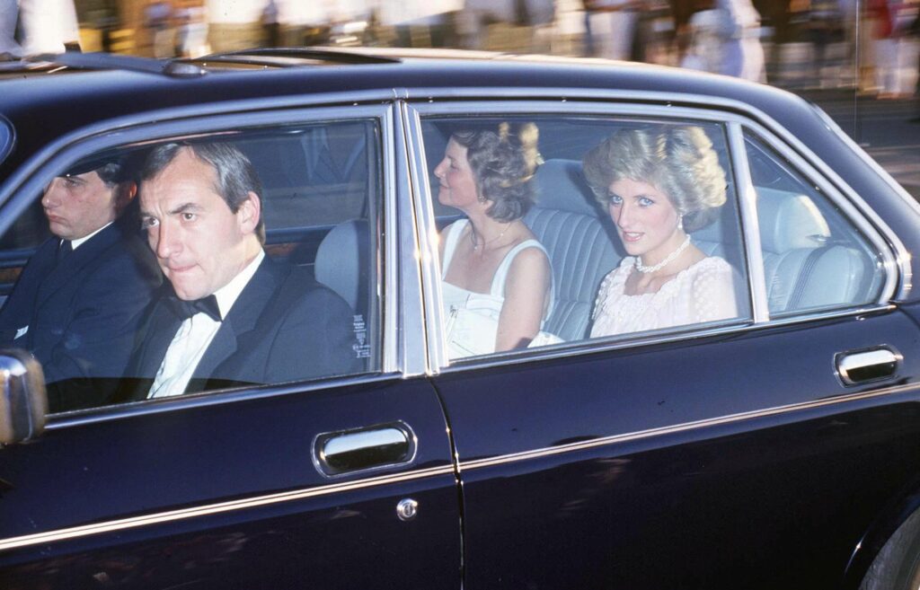 Barry Mannakee (front seat of the car, passenger side) and Princess Diana (back seat of the car, passenger side) looking out of the windows of a car