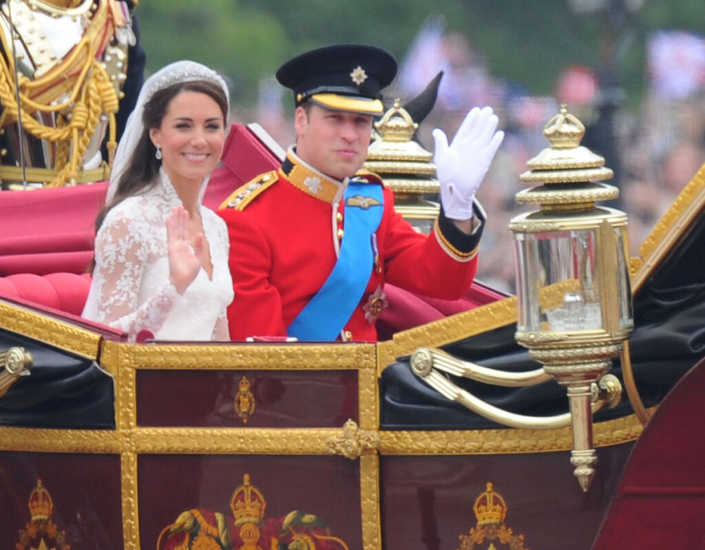 Princess Kate Middleton and Prince William on their royal wedding day waving from a carriage