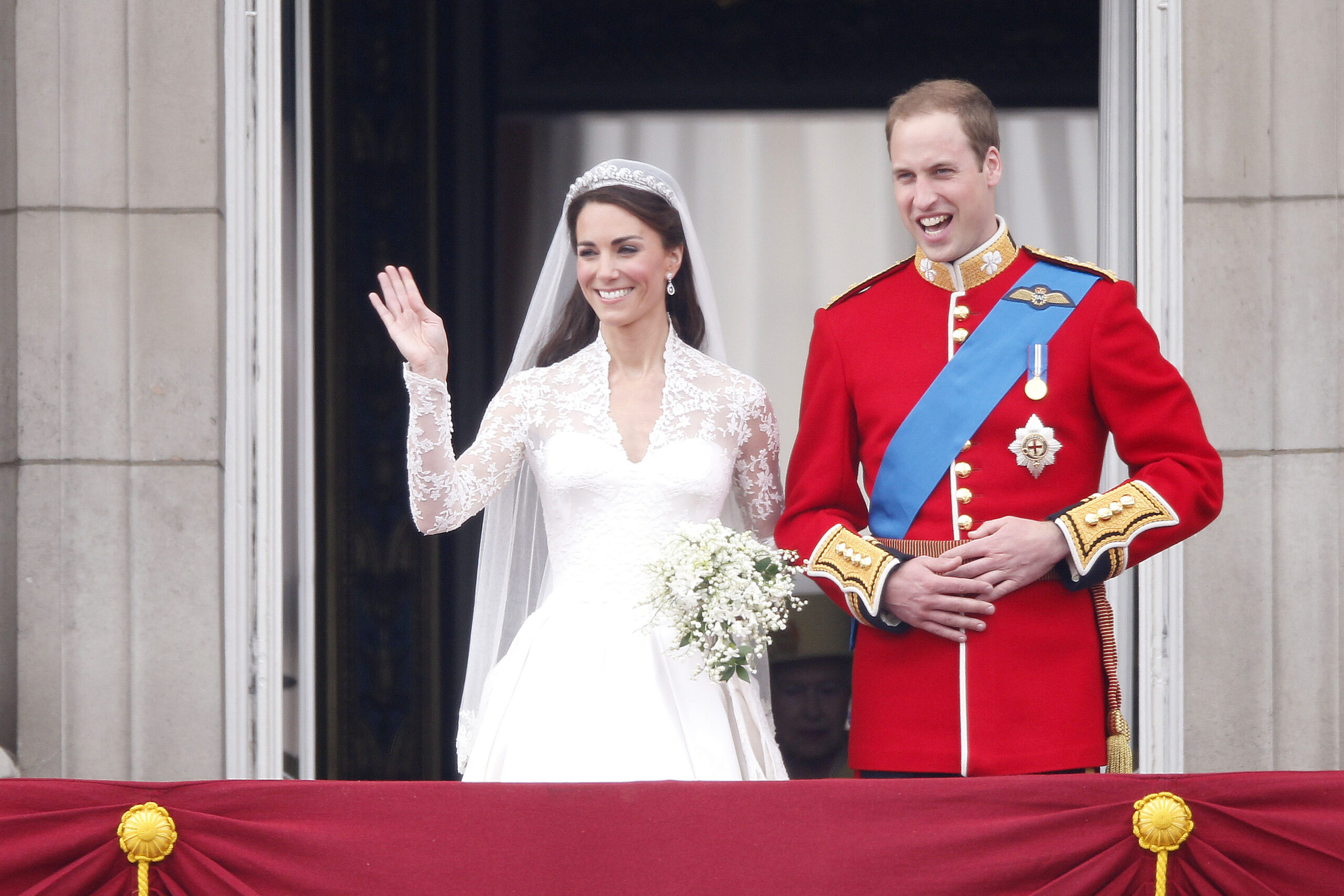 Princess Kate Middleton and Prince William on their royal wedding day waving from Buckingham Palace