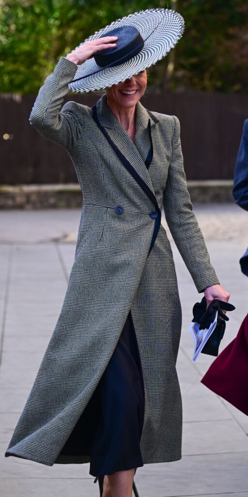 Kate Middleton holding onto her hat