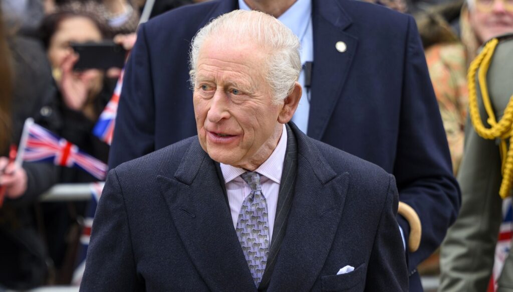 King Charles in suit and coat on royal outing