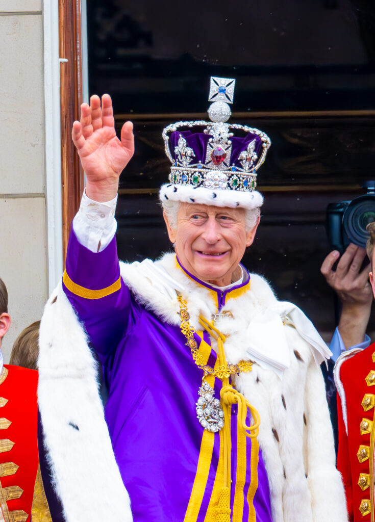 King Charles waving from palace during coronation