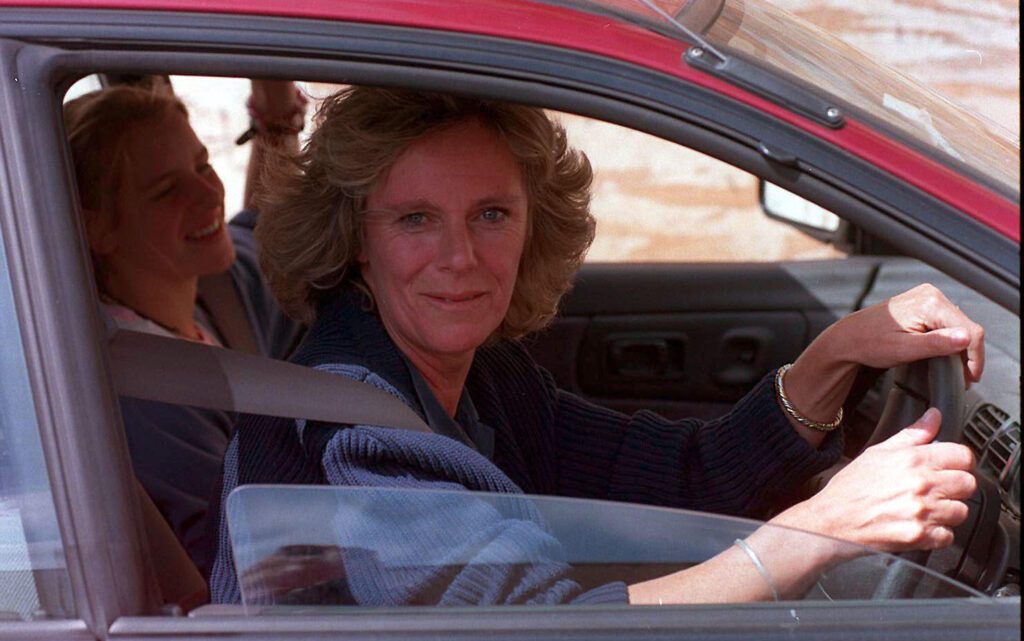 Queen Camilla driving a red car in 1997