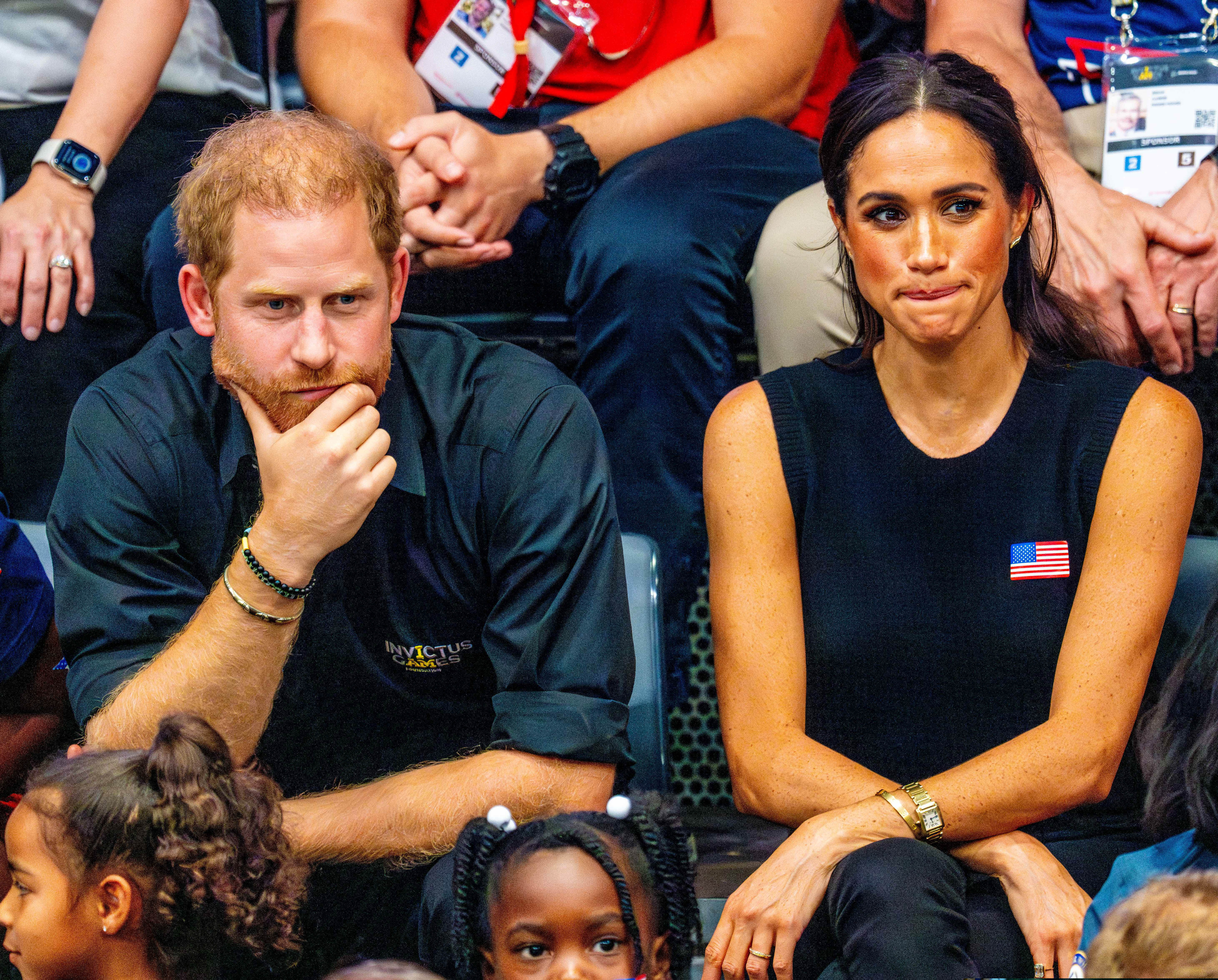 Prince Harry and Meghan Markle frowning