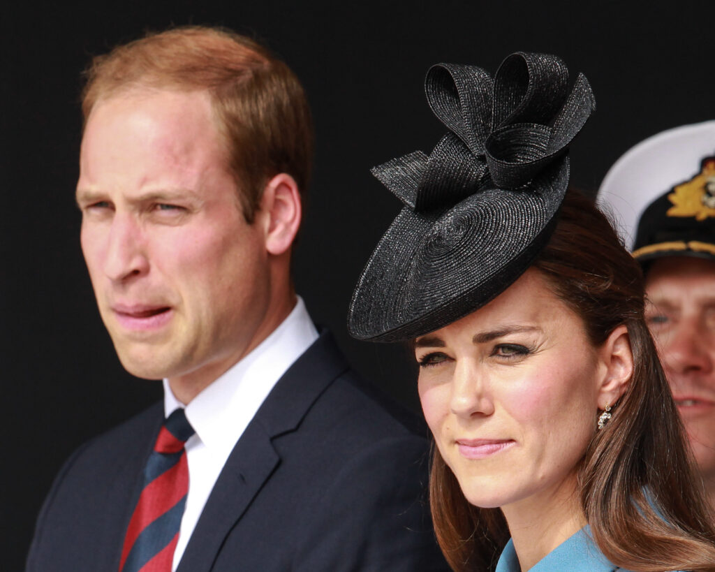 Prince William and Kate Middleton with strained expressions stood side by side