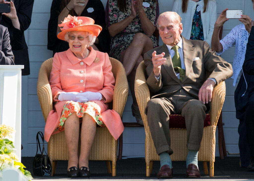 Queen Elizabeth and Prince Philip sat in chairs side by side
