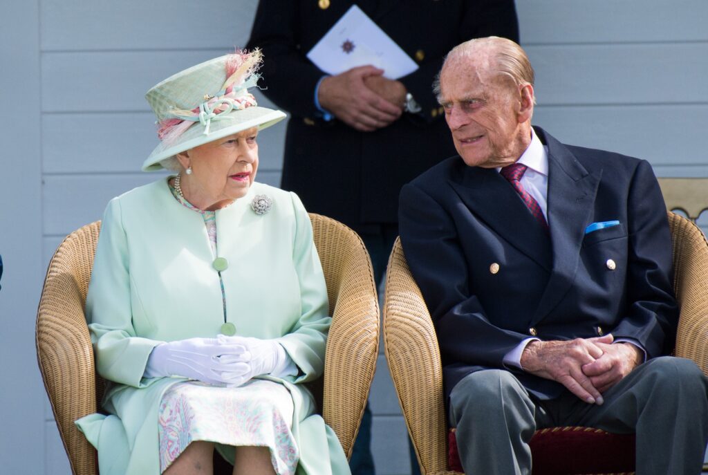 Queen Elizabeth and Prince Philip looking at each other