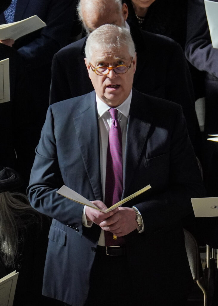 Andrew Mountbatten-Windsor singing holding a hymn book