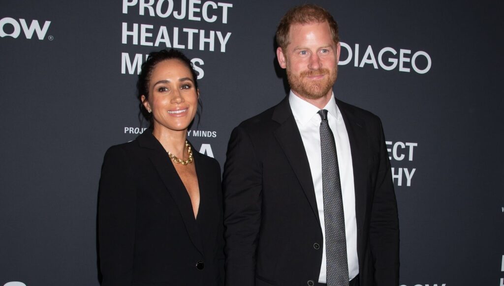 Meghan Markle and Prince Harry smiling at event