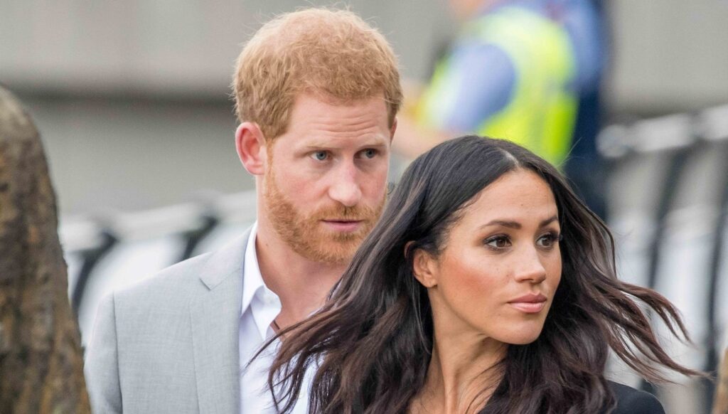 Prince Harry and Meghan Markle looking to the side
