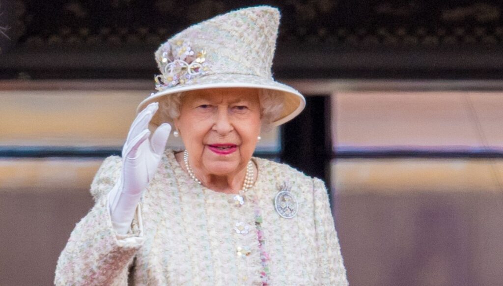 Queen Elizabeth II waving in white outfit