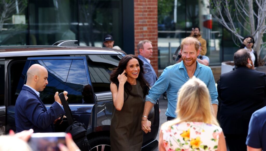 Meghan Markle and Prince Harry smiling in Australia