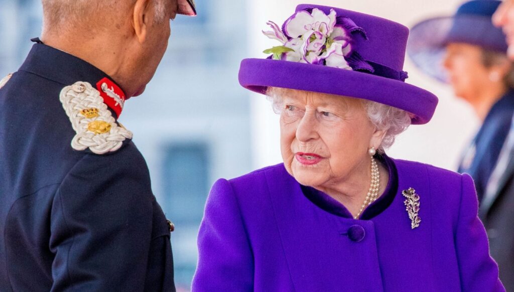 Queen Elizabeth II in purple outfit