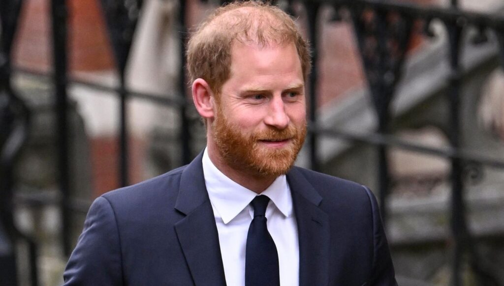 Prince Harry smiling in blue suit