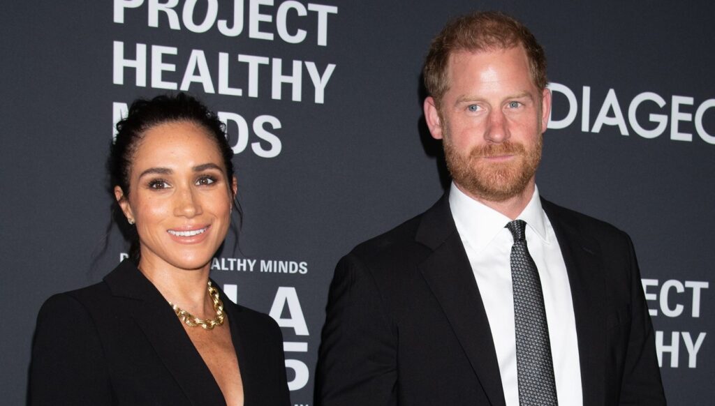 Meghan Markle and Prince Harry smiling at event