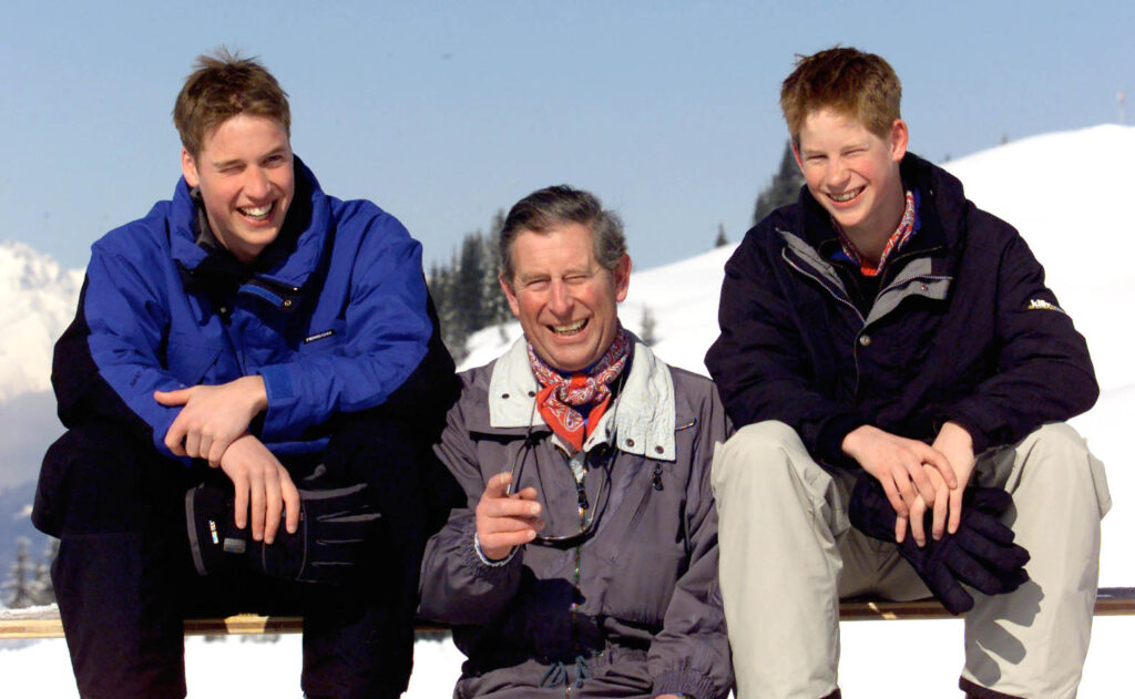 Young Prince William, Prince Charles and Prince Harry smiling on a ski holiday