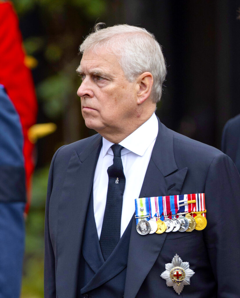 Andrew Mountbatten-Windsor frowning and looking away from the camera