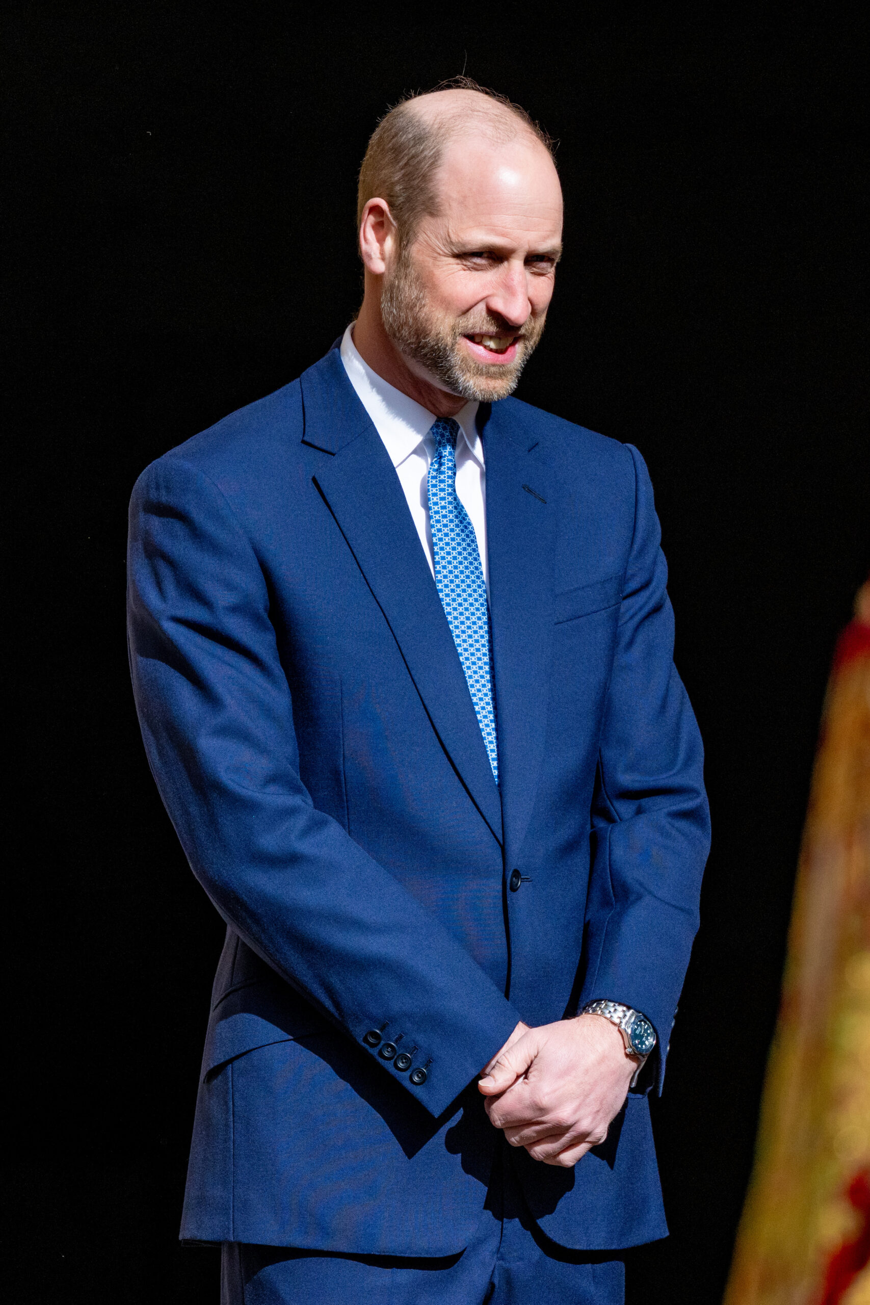 Prince William looking down and smiling