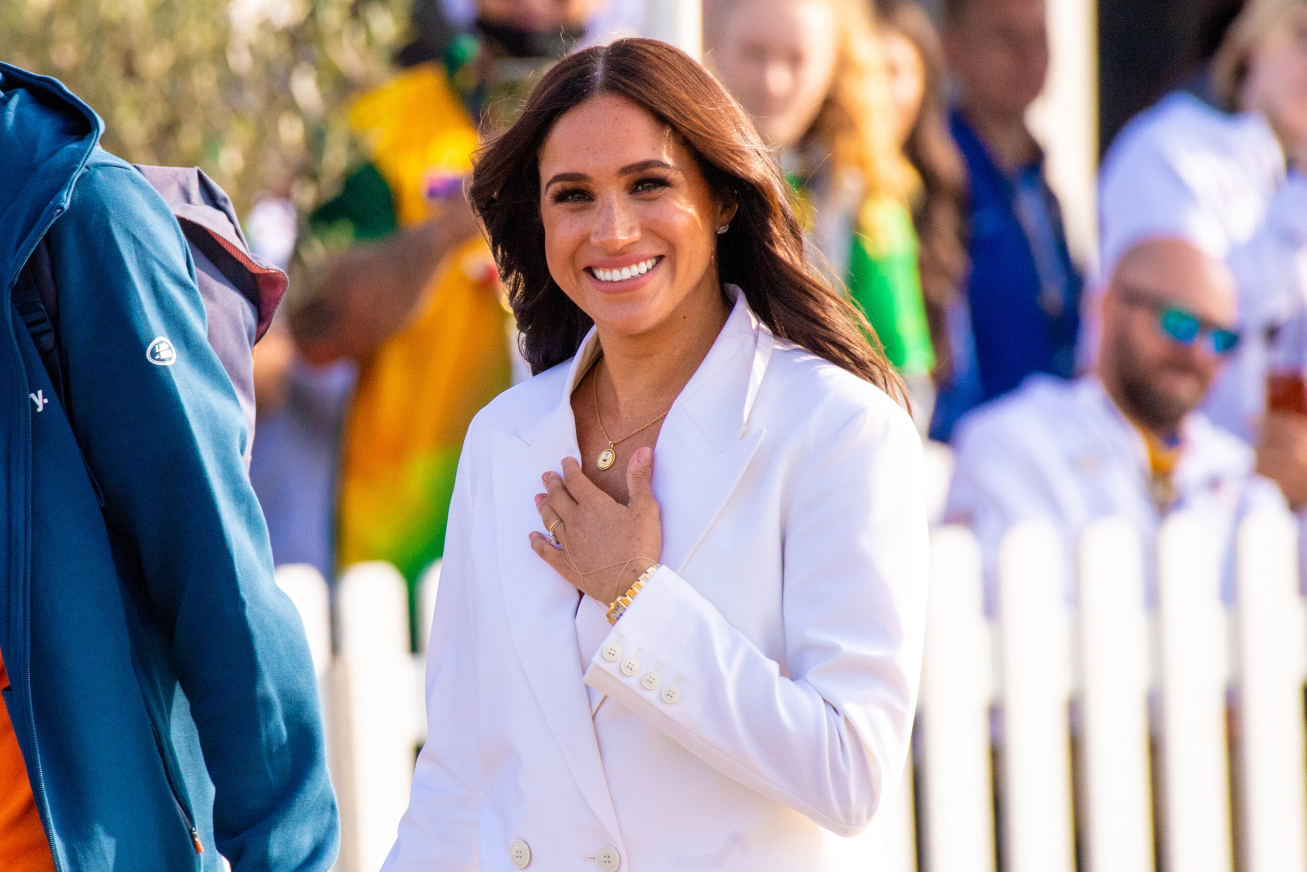 Meghan Markle smiling and walking